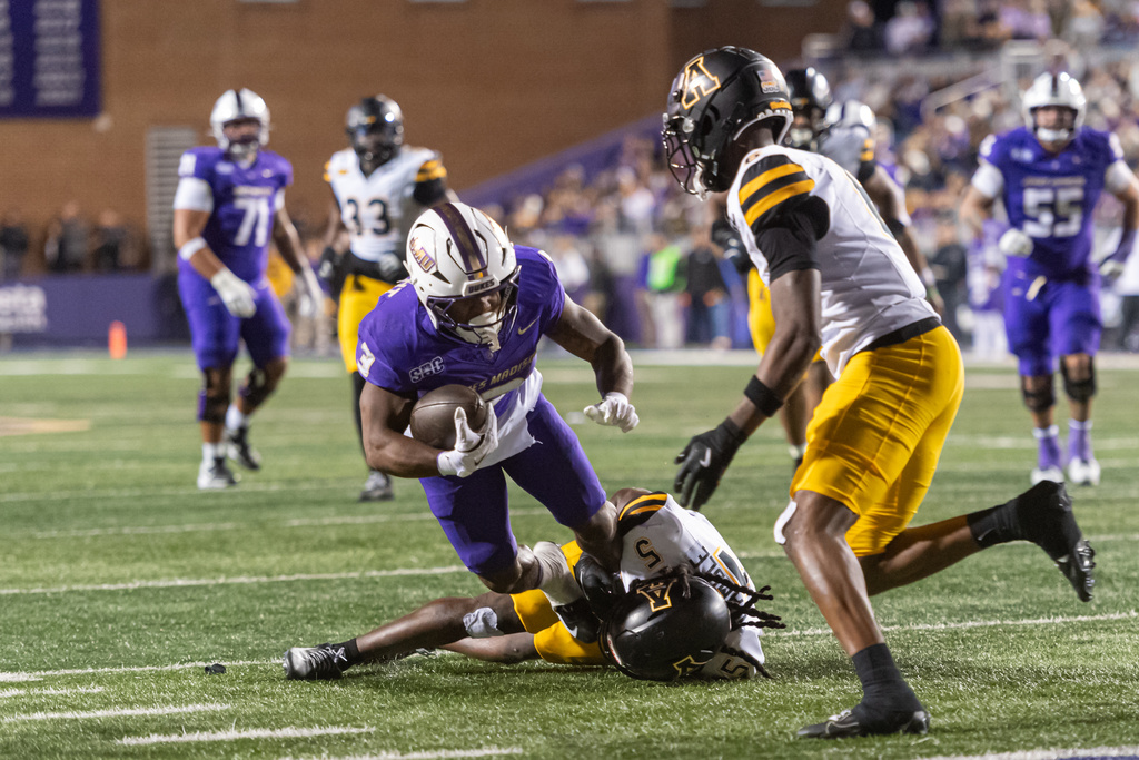 James Madison running back Wayne Knight (3) is tackled by Appalachian State defensive back Zyeir Gamble (5) during the second half of an NCAA college football game, Saturday, Nov. 15, 2025, Harrisonburg, Va. (AP Photo/Robert Simmons)