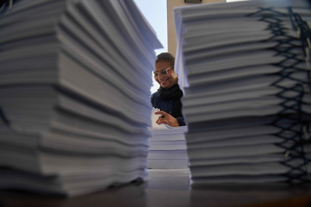 FILE - A staff member checks a voter list before distribution to various regions across the country for the upcoming general election scheduled for March 5, at the Election Commission in Kathmandu, Nepal, on Jan. 30, 2026. (AP Photo/Niranjan Shrestha, File)