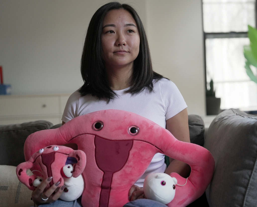 Zoë Armstrong, an endometriosis patient, sits for a photo in her home in New York, Friday, Aug. 14, 2026. (AP Photo/Shelby Lum)