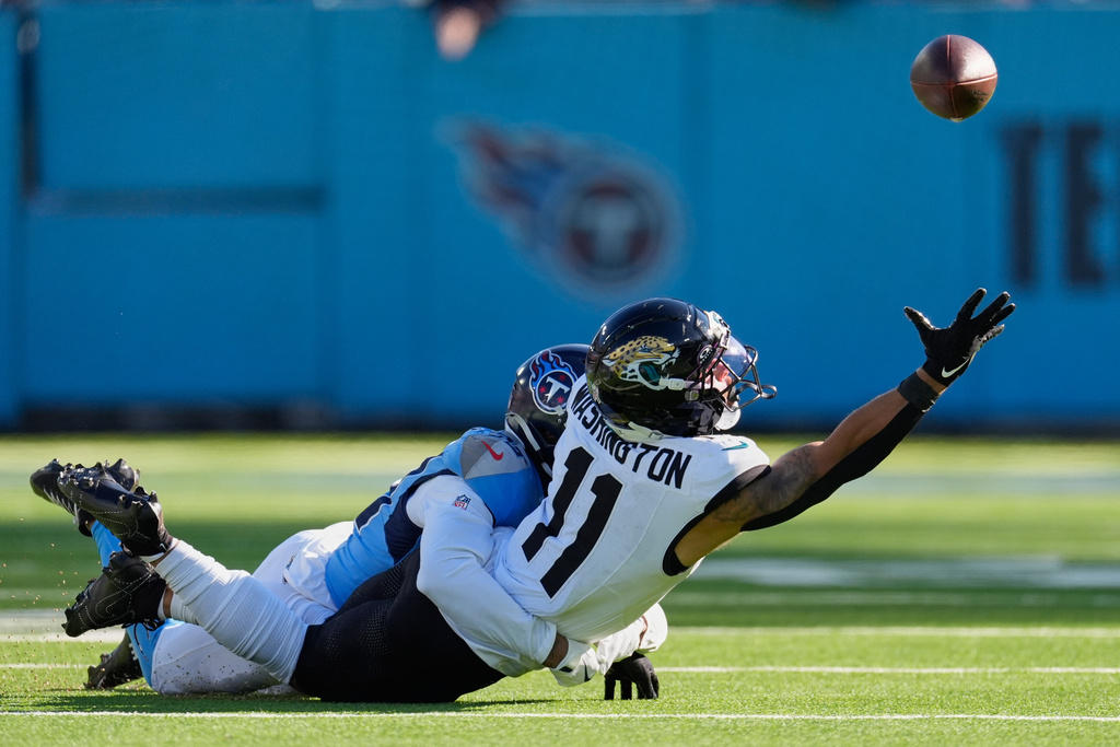 Tennessee Titans cornerback Darrell Baker Jr., left, breaks up a pass intended for Jacksonville Jaguars wide receiver Parker Washington (11) during the first half of an NFL football game Sunday, Nov. 30, 2025, in Nashville, Tenn. (AP Photo/George Walker IV)