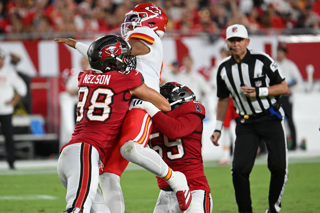 Tampa Bay Buccaneers linebacker Anthony Nelson (98) hits Kansas City Chiefs quarterback Justin Fields (6) in the first half of an NFL preseason football game, Saturday, Aug. 22, 2026, in Tampa, Fla. (AP Photo/Mark LoMoglio)