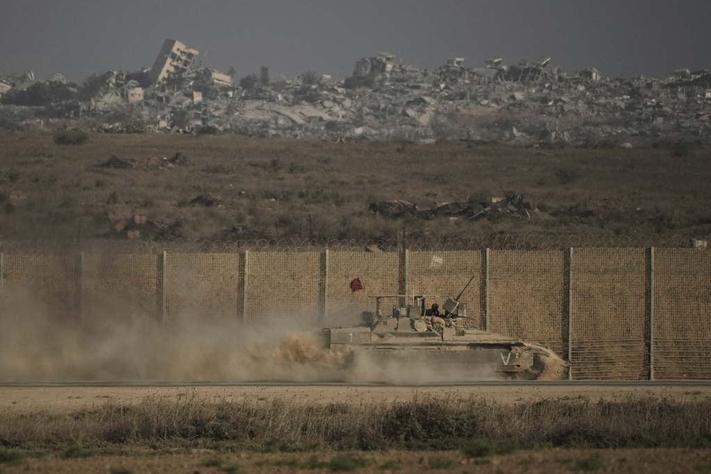 An Israeli armored vehicle moves along the Israeli-Gaza border as seen from southern Israel, Tuesday, Sept. 16, 2025. (AP Photo/Leo Correa)