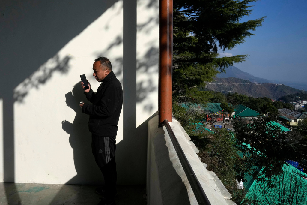 Sonam Tashi talks on his mobile phone from Tibetan Children's Village school in Mcleodganj near Dharamshala, India, March 6, 2025. (AP Photo/Manish Swarup)