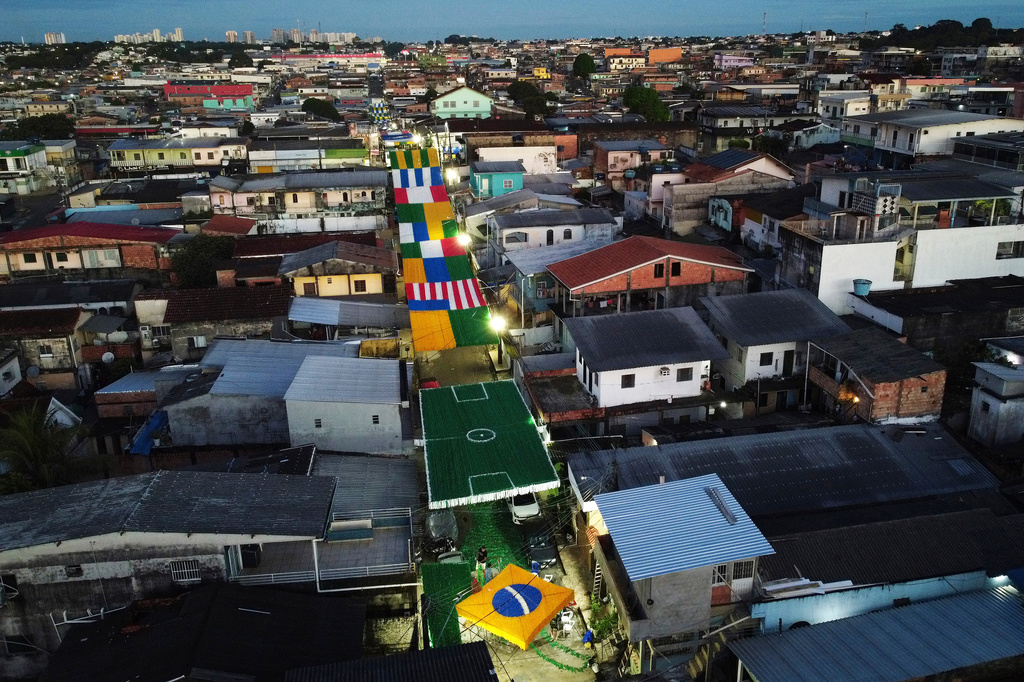 Residents set up decorations ahead of the 2026 FIFA World Cup, in Manaus, Brazil, Sunday, May 17, 2026. (AP Photo/Edmar Barros)