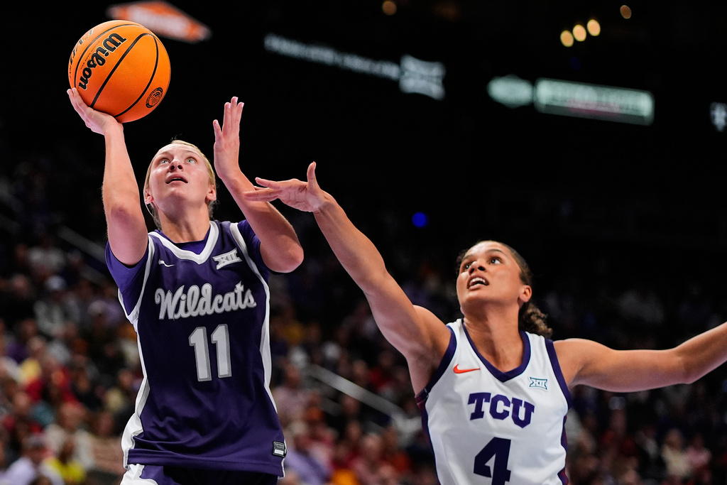 Kansas State's Taryn Sides (11) gets past TCU's Donovyn Hunter (4) to put up a shot during first half of an NCAA college basketball game in the semifinals of the Big 12 Conference tournament Saturday, March 7, 2026, in Kansas City, Mo. (AP Photo/Charlie Riedel)