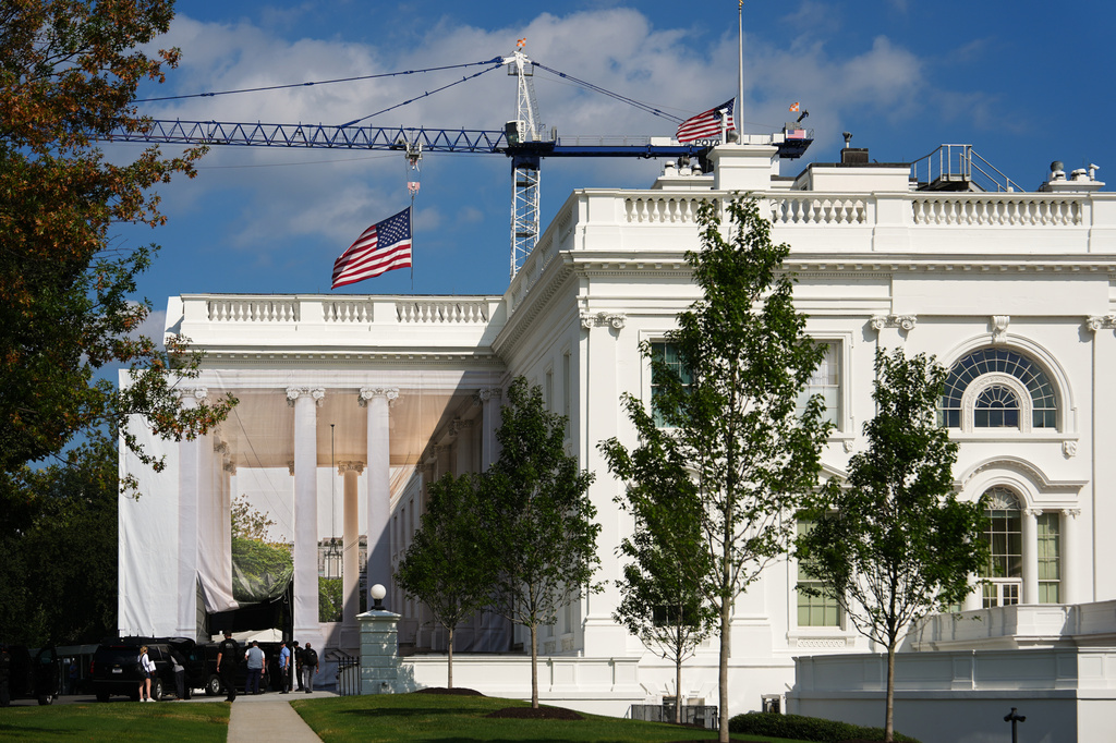 American flags fly at half staff in honor of Dolly Parton, Sunday, Aug. 30, 2026, at the White House in Washington. (AP Photo/Julia Demaree Nikhinson)