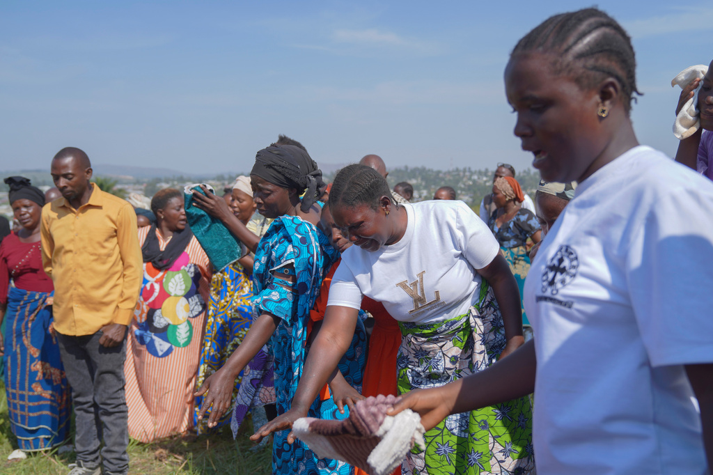 People weep as they attend the burial ceremony of Neema Minaro, a 66 year old woman who died of the Ebola virus, in Bunia, Congo, Wednesday, Sept. 2, 2026. (AP Photo/Dieudonne Dirole)
