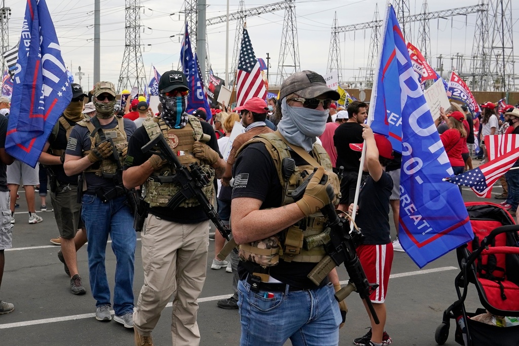 FILE - Supporters of President Donald Trump rally outside the Maricopa County Recorder's Office, Friday, Nov. 6, 2020, in Phoenix. (AP Photo/Ross D. Franklin)