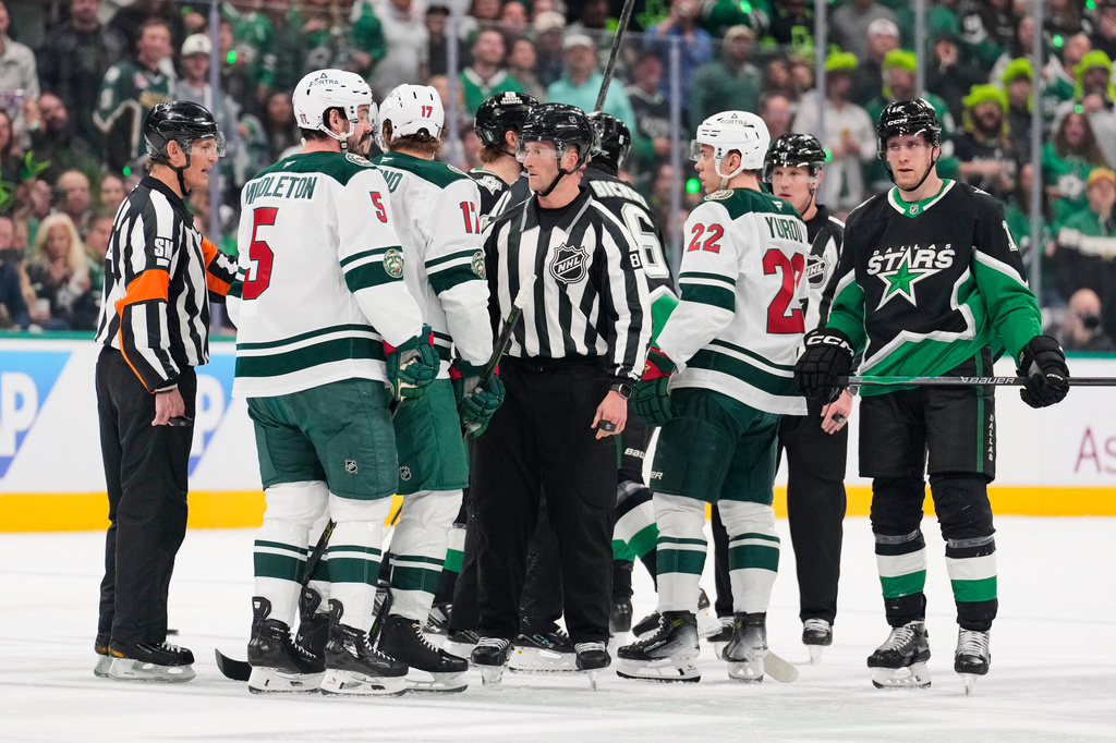 Minnesota Wild and Dallas Stars players are separated by officials after scuffles broke out following an injury to the Wild's Yakov Trenin in the first period of Game 2 of a first-round NHL Stanley Cup playoffs hockey series Monday, April 20, 2026, in Dallas. (AP Photo/Tony Gutierrez)un