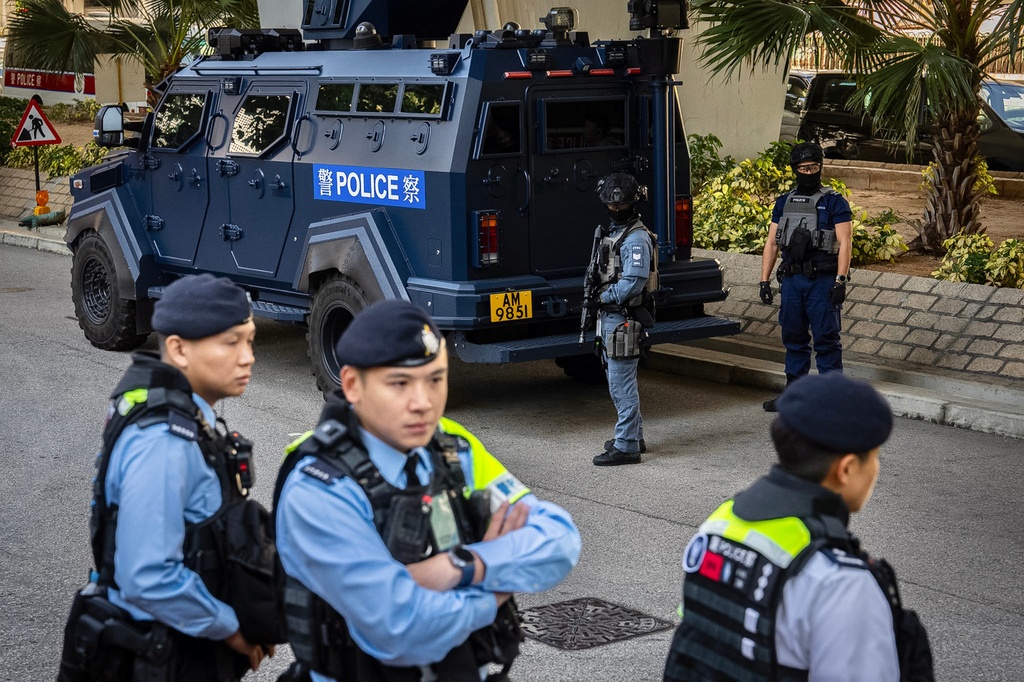 Armed police stand guard outside the West Kowloon Magistrates' Courts following the verdict for Hong Kong activist publisher Jimmy Lai's national security trial in Hong Kong, Monday, Dec. 15, 2025. (AP Photo/Chan Long Hei)