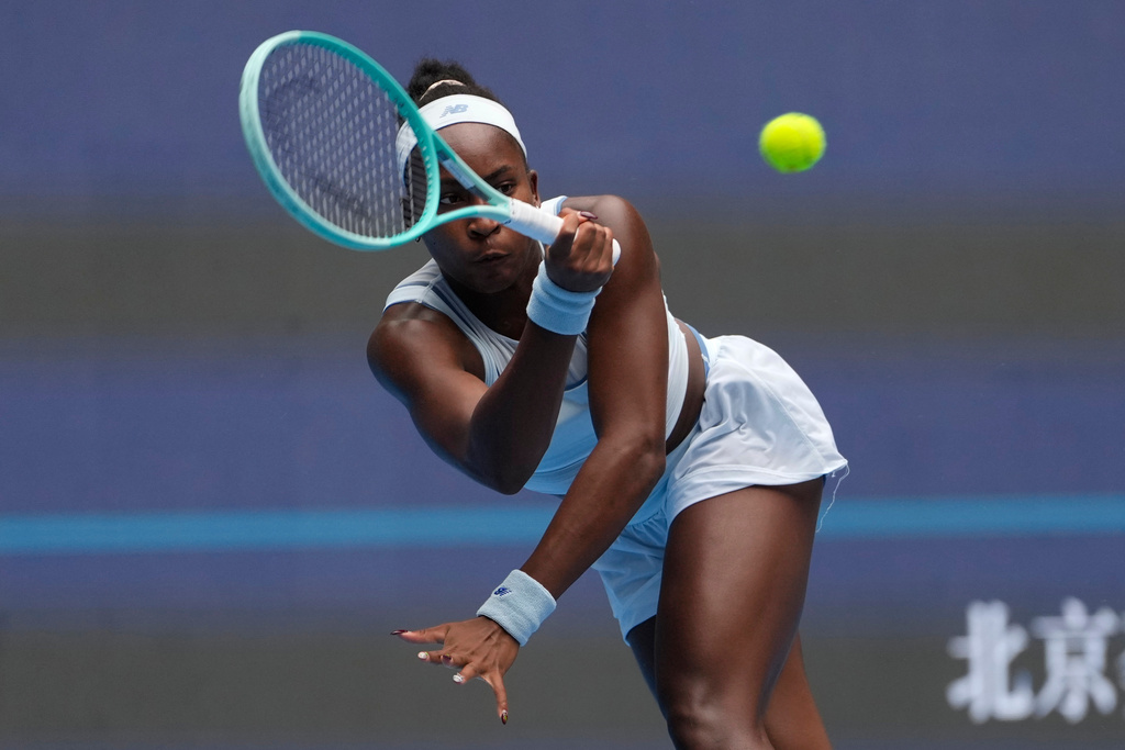 Coco Gauff of the United States returns a shot from compatriot Amanda Anisimova in a women's singles semifinal match of the China Open tennis tournament in Beijing, China, Saturday, Oct. 4, 2025.(AP Photo/Ng Han Guan)