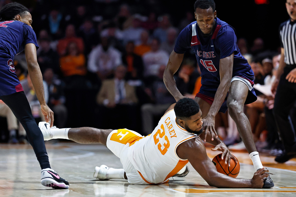 Tennessee forward Jaylen Carey (23) battles for the ball with South Carolina State center Tim Okojie (15) during the first half of an NCAA college basketball game Tuesday, Dec. 30, 2025, in Knoxville, Tenn. (AP Photo/Wade Payne)