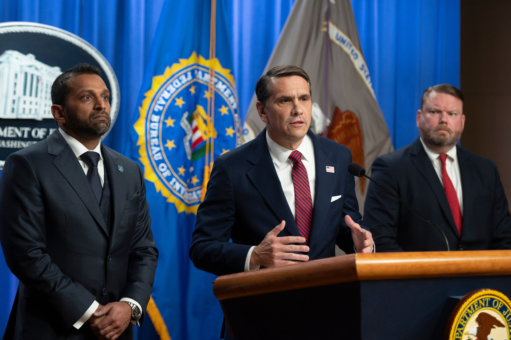 FBI Director Kash Patel, left, and Ellis Boyle, U.S. Attorney for the Eastern District of N.C., right, look on as Acting Attorney General Todd Blanche announces that former FBI Director James Comey has been indicted, at the Justice Department in Washington, Tuesday, April 28, 2026. (AP Photo/Cliff Owen)