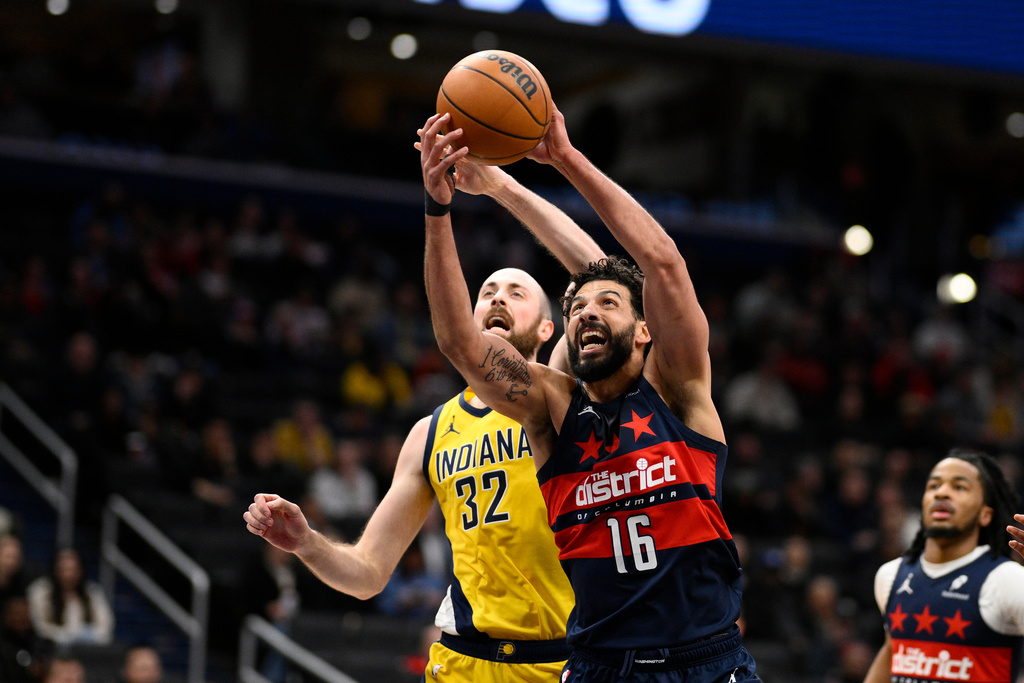 Washington Wizards forward Anthony Gill (16) and Indiana Pacers center Jay Huff (32) battle for the ball during the first half of an NBA basketball game, Thursday, Feb. 19, 2026, in Washington. (AP Photo/Nick Wass)