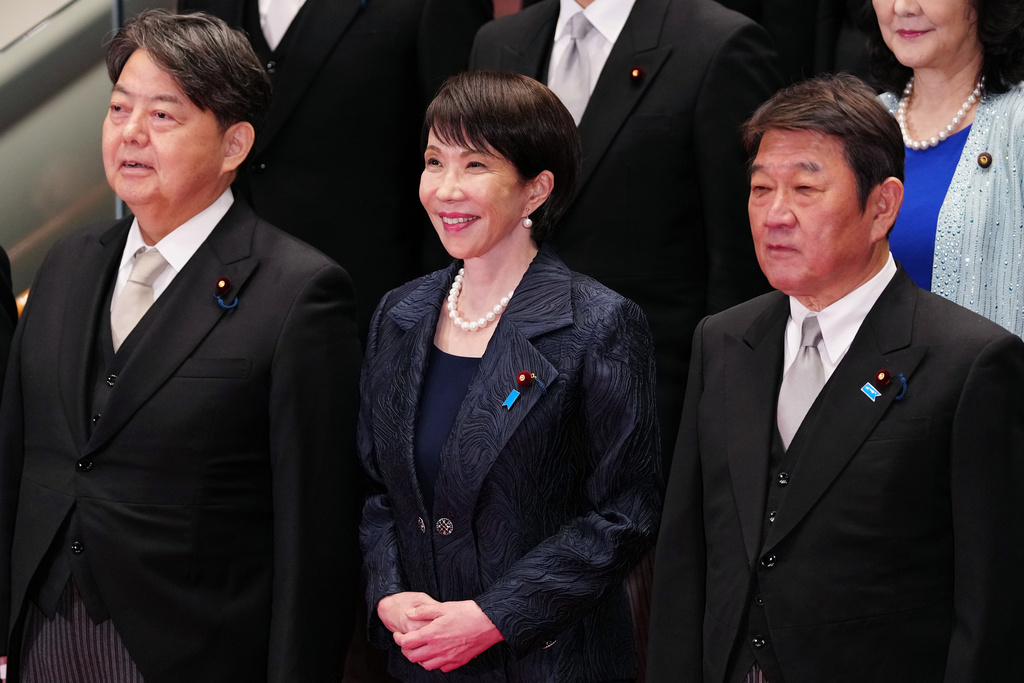 Japan Prime Minister Sanae Takaichi, front center, and her new cabinet members pose for a group photo in Tokyo, Oct. 21, 2025. (Jia Haocheng/Pool via AP)