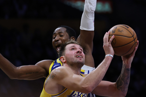 Los Angeles Lakers guard Luka Doncic (77) attempts a shot against the Golden State Warriors during the second half of an NBA basketball game Tuesday, Oct. 21, 2025, in Los Angeles. (AP Photo/Ethan Swope) Los Angeles Lakers guard Luka Doncic (77) attempts a shot against the Golden State Warriors during the second half of an NBA basketball game Tuesday, Oct. 21, 2025, in Los Angeles. (AP Photo/Ethan Swope)