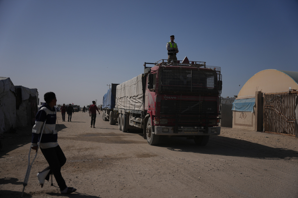 Trucks carrying food, after entering the Gaza Strip through the Kerem Shalom crossing, drive through Khan Younis, Sunday, Feb. 1, 2026. (AP Photo/Abdel Kareem Hana)