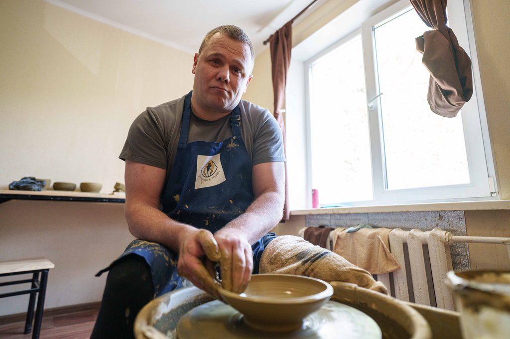 Ivan Shostak, a blind Ukrainian war veteran makes a clay plate on a pottery wheel at his apartment in Vinnytsia, Ukraine, on, May 21, 2026. (AP Photo/Evgeniy Maloletka)
