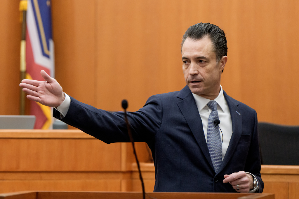 Brad Bloodworth, chief prosecutor for Summit County, motions toward Kouri Richins, a Utah mother accused of fatally poisoning her husband, while delivering his opening statement in Richins' trial at the Summit County Courthouse in Park City, Utah, Monday, Feb. 23, 2026. (AP Photo/Spenser Heaps, Pool)