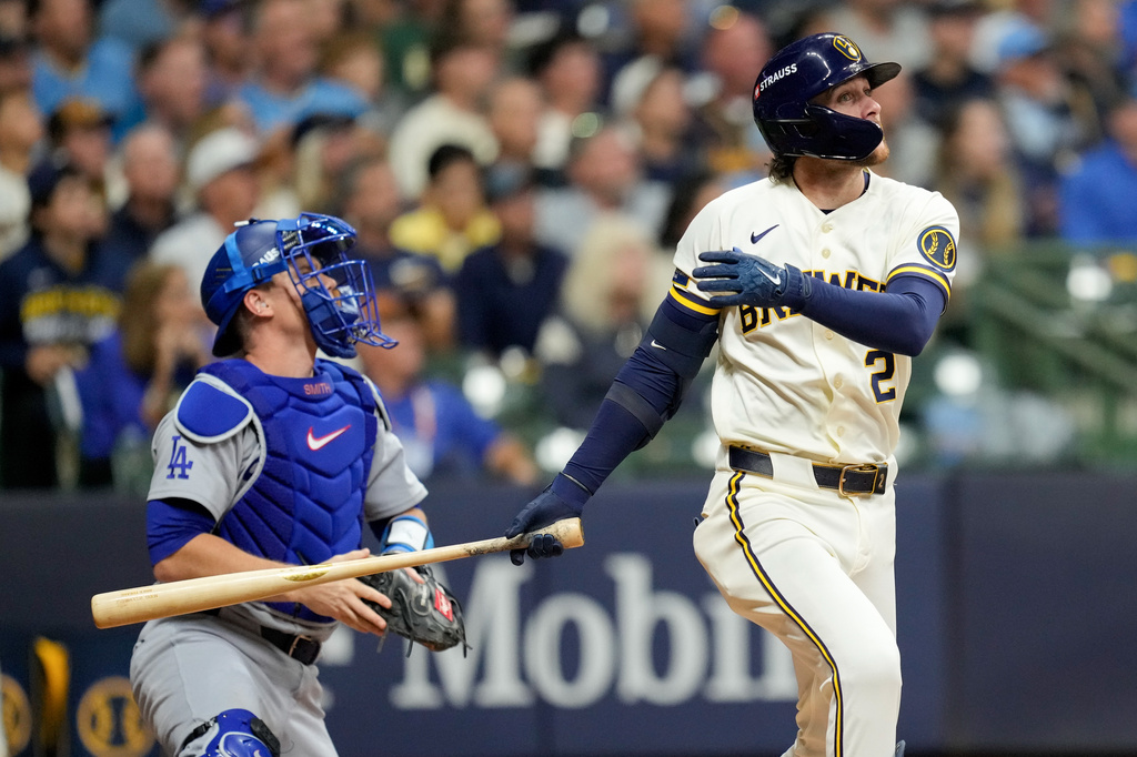 Milwaukee Brewers second baseman Brice Turang and Los Angeles Dodgers catcher Will Smith watch his solo home run take flight during the fourth inning of Game 1 of baseball's National League Championship Series between the Milwaukee Brewers and the Los Angeles Dodgers, Sunday, Oct. 11, 2026, in Milwaukee. (AP Photo/Ashley Landis)