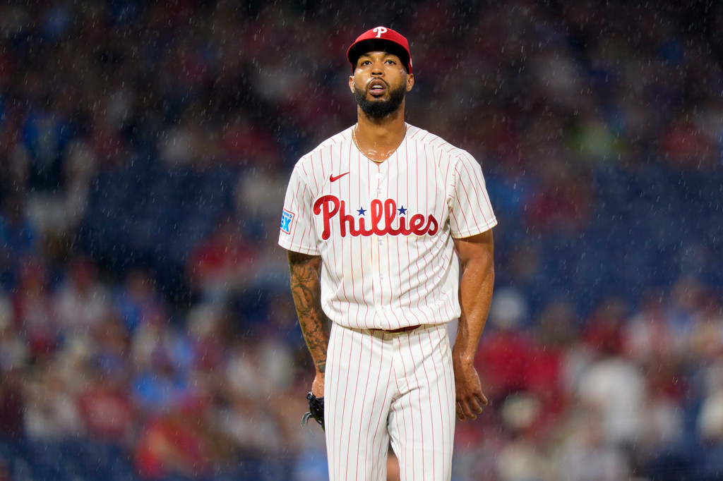 Philadelphia Phillies starting pitcher Cristopher Sanchez looks on as rain falls during the sixth inning of a baseball game against the Miami Marlins, Monday, Aug. 17, 2026, in Philadelphia. (AP Photo/Chris Szagola)