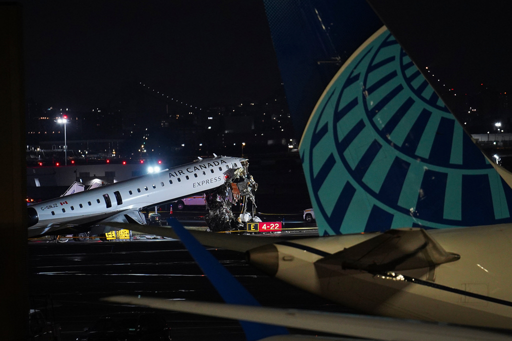 An Air Canada jet sits on the runway at LaGuardia Airport, Monday, March 23, 2026, after colliding with a Port Authority aircraft rescue and firefighting vehicle after landing in New York. (AP Photo/Ryan Murphy)