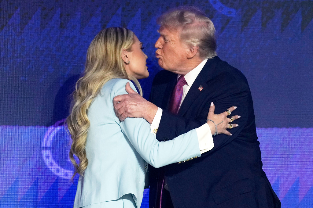 President Donald Trump greets Turning Point CEO Erika Kirk at a Turning Point USA event Friday, April 17, 2026, in Phoenix. (AP Photo/Ross D. Franklin)