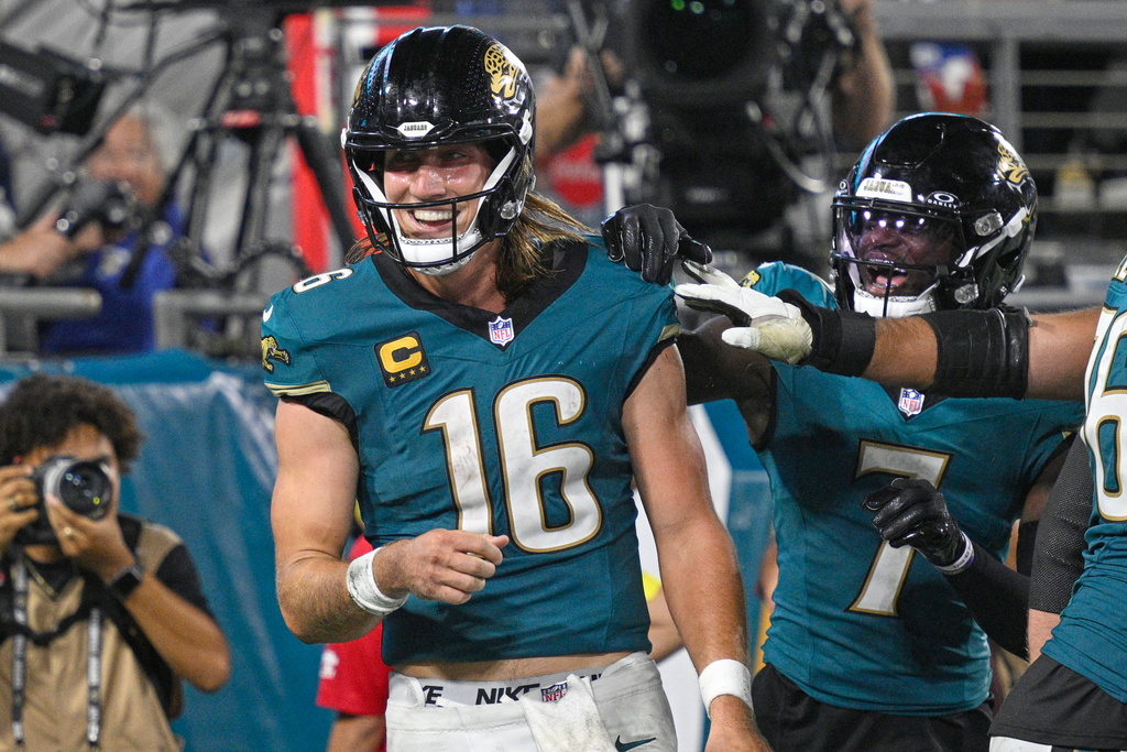 Jacksonville Jaguars quarterback Trevor Lawrence (16) celebrates with teammates after scoring a touchdown during the second half of an NFL football game against the Kansas City Chiefs, Monday, Oct. 6, 2025, in Jacksonville, Fla. (AP Photo/Phelan M. Ebenhack)