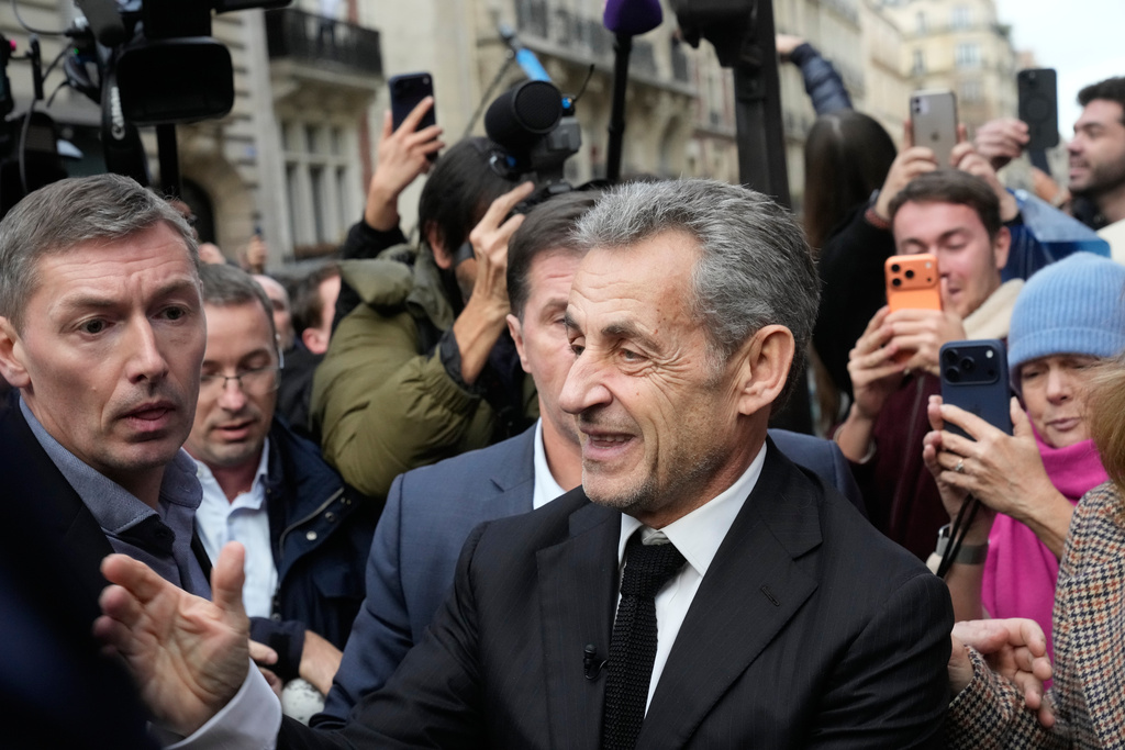 Former French President Nicolas Sarkozy arrives to sign his book "Diary of a Prisoner," in a Paris bookshop, Wednesday, Dec. 10, 2025. (AP Photo/Michel Euler)