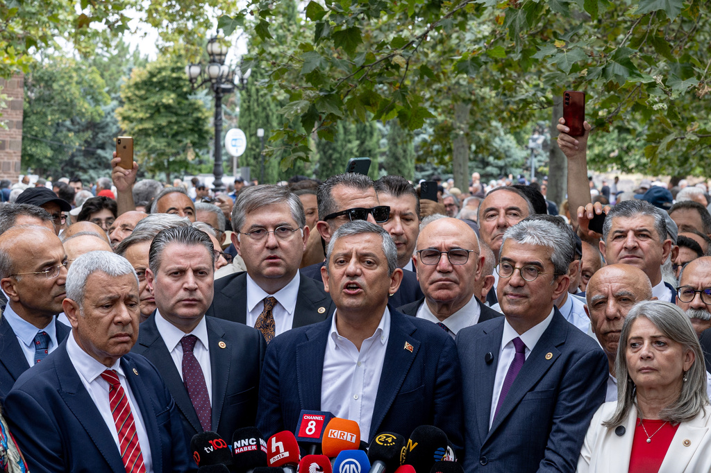 Turkey's deposed main opposition Republican People's Party (CHP) leader Ozgur Ozel, center, talks to the media after submitting a registration petition to create a new party called "Yeni Party" in Ankara, Turkey, Friday, July 24, 2026. (Ugur Yildirim/DIA Photo via AP)