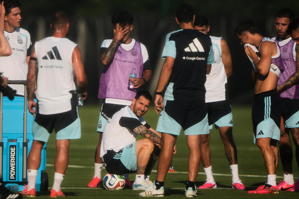 Argentina forward Lionel Messi, sitting, takes a break with teammates during practice for the FIFA World Cup soccer Wednesday, June 3, 2026, in Kansas City, Kan. (AP Photo/Charlie Riedel)