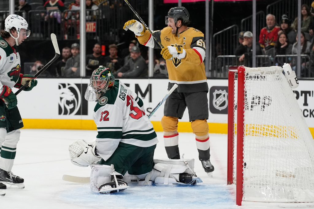 Vegas Golden Knights right wing Mark Stone (61) celebrates after a goal by Vegas Golden Knights defenseman Brayden McNabb against Minnesota Wild goaltender Filip Gustavsson (32) during the second period of an NHL hockey game Monday, Dec. 29, 2025, in Las Vegas. (AP Photo/John Locher)
