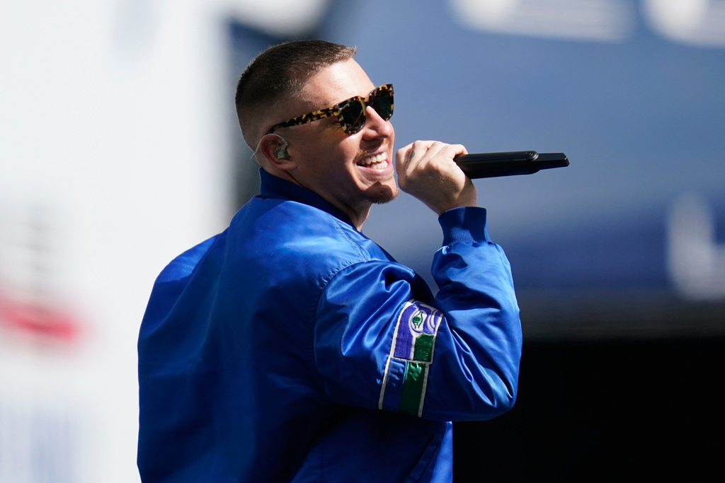 FILE - Rap singer Macklemore performs before an NFL football game between the Seattle Seahawks and the Tennessee Titans, Sept. 19, 2021, in Seattle. (AP Photo/Elaine Thompson, File)