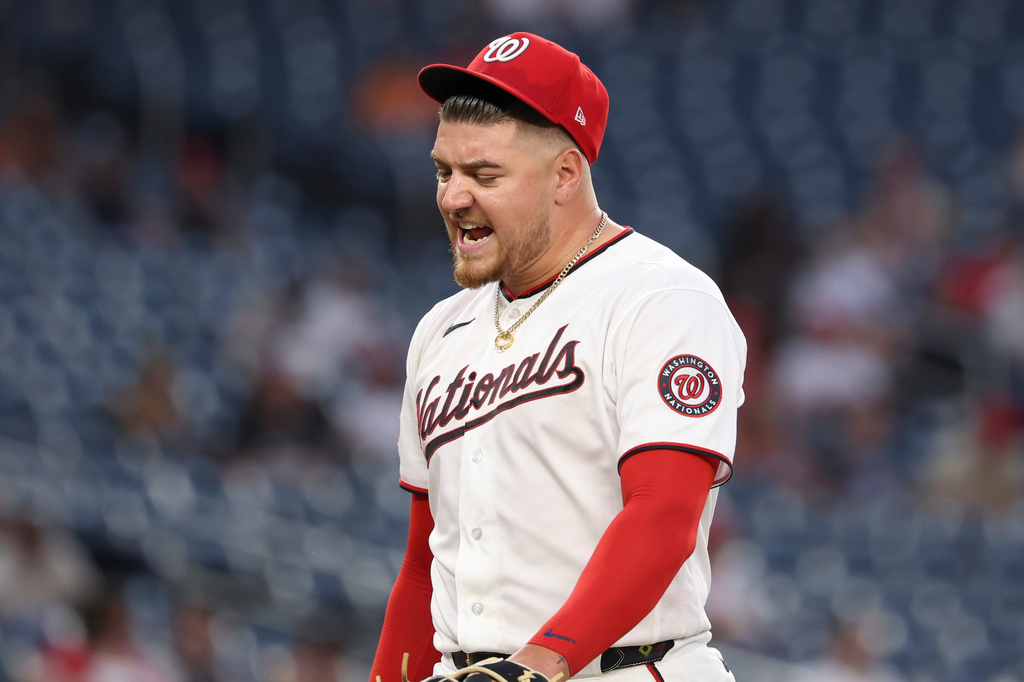 Washington Nationals pitcher Cade Cavalli reacts as he walks on the field during the third inning of a baseball game against the Colorado Rockies in Washington, Monday, Aug. 24, 2026. (AP Photo/Terrance Williams)