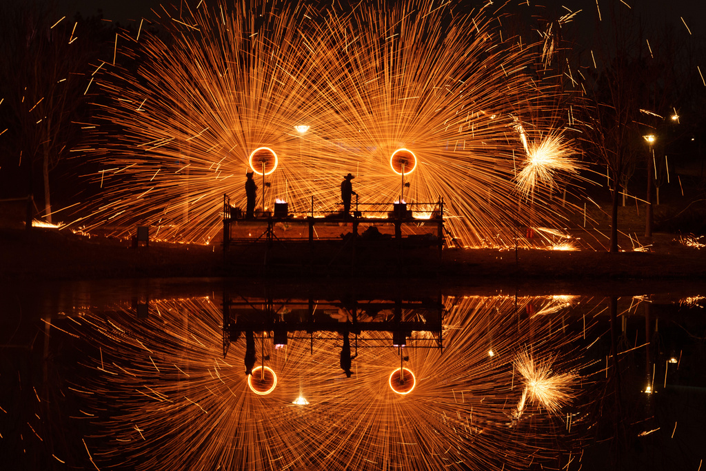 Chinese folk performance known as da shuhua, or molten iron fireworks ahead of Lunar New Year celebrations in Beijing, China, Monday, Feb. 9, 2026. (AP Photo/Vincent Thian)