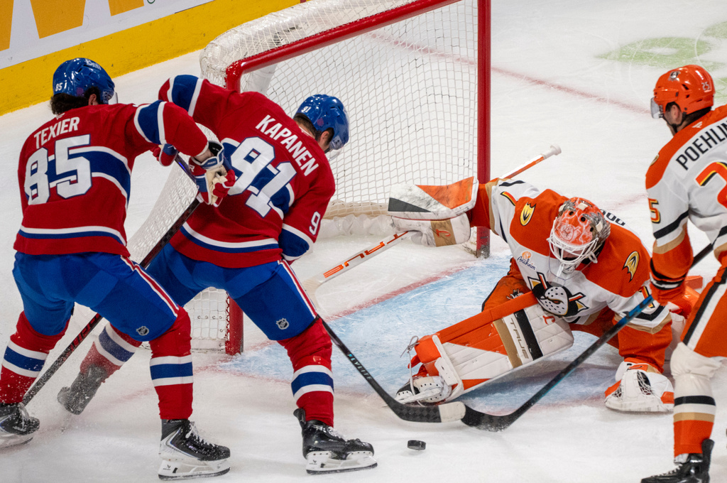 Anaheim Ducks goaltender Lukas Dostal, second from right, stops a shot by Montreal Canadiens' Oliver Kapanen (91) as Canadiens' Alexandre Texier (85) skates in for a rebound during first-period NHL hockey game action in Montreal, Sunday, March 15, 2026. (Christinne Muschi/The Canadian Press via AP)