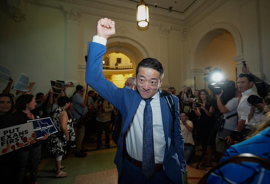 Rep. Gene Wu, D-Houston, raises his fist as he returns to the House Chamber at the Capitol, Monday, Aug. 18, 2025, in Austin, Texas. (Jay Janner/Austin American-Statesman via AP)