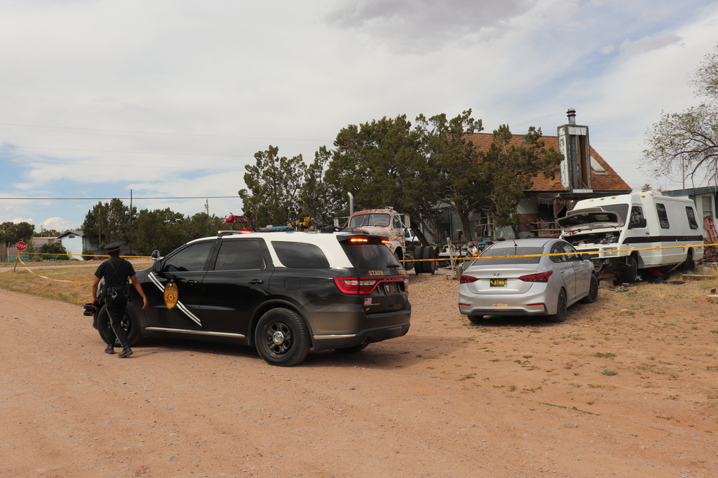 New Mexico State Police respond to home in Mountainair, N.M., where authorities say several people died Wednesday, May 20, 2026, and more than a dozen first responders were exposed to an unknown substance and later treated at a hospital. (AP Photo/Savannah Peters)