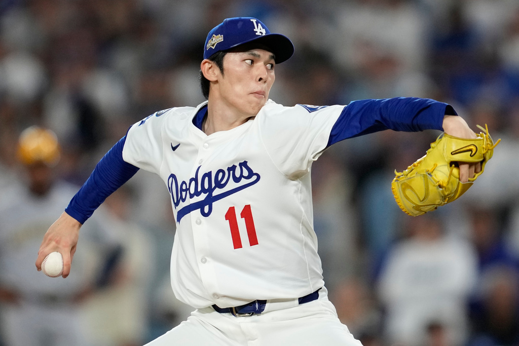 Los Angeles Dodgers pitcher Roki Sasaki throws against the Milwaukee Brewers during the ninth inning in Game 4 of baseball's National League Championship Series, Friday, Oct. 17, 2025, in Los Angeles. (AP Photo/Ashley Landis)