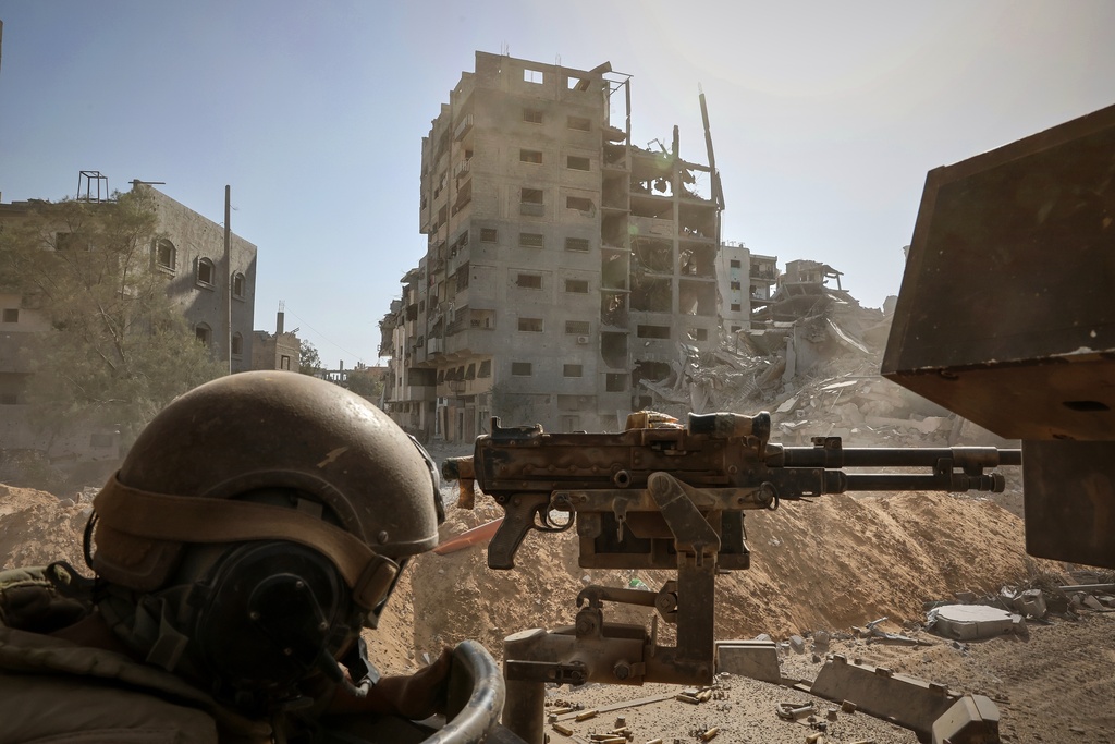 This picture taken during a media tour organised by the Israeli army shows an Israeli army soldier behind a mounted machine gun in the vicinity of the Jordanian Field Hospital in Gaza City, Friday, Oct. 3, 2025. (Jack Guez/Pool Photo via AP)