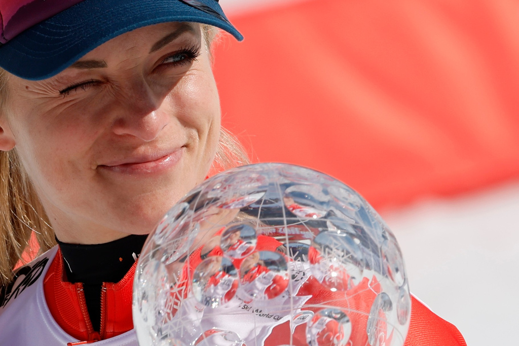 FILE - Switzerland's Lara Gut Behrami holds the trophy for the alpine ski, women's World Cup super-G discipline, in Saalbach, Austria, Friday, March 22, 2024. (AP Photo/Alessandro Trovati, File)