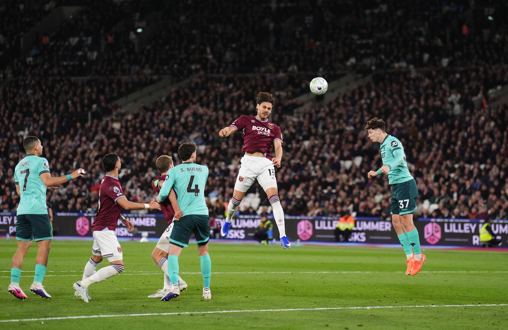 West Ham United's Konstantinos Mavropanos, center, scores their side's first goal of the game during their English Premier League soccer match against Wolverhampton Wanderers in London, Friday, April 10, 2026. (John Walton/PA via AP)