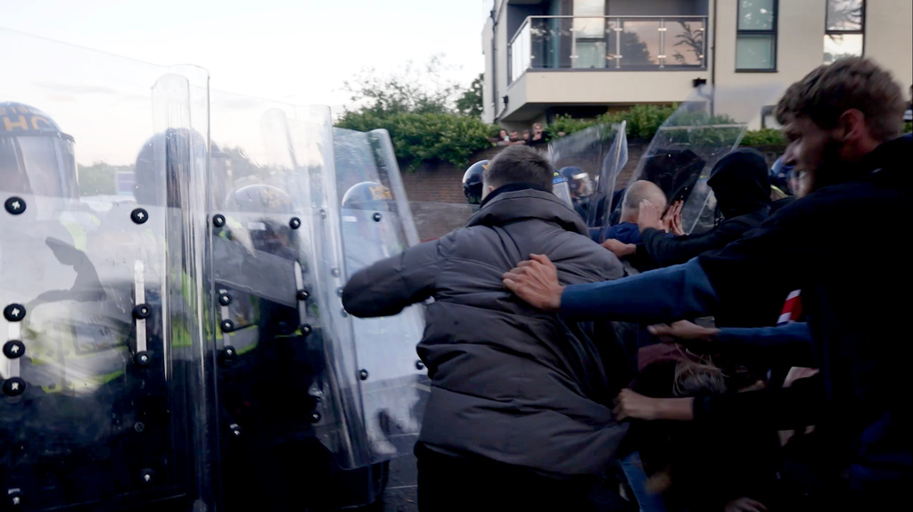 In this image taken from PA Video, police and protestors clash during a protest following the death of Henry Nowak, a 18-year-old student stabbed to death with a Sikh kirpan ceremonial by Vickrum Digwa, in Southampton, England, Tuesday June 2, 2026. (Jamie Lashmar/PA via AP)
