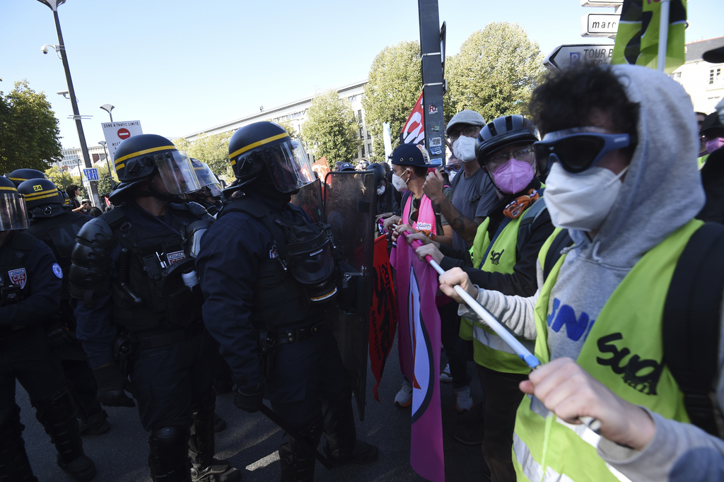 Demonstrators face police during a protest called by major trade unions to oppose budget cuts, in Nantes, western France, Thursday, Sept. 18, 2025. (AP Photo/Mathieu Pattier)