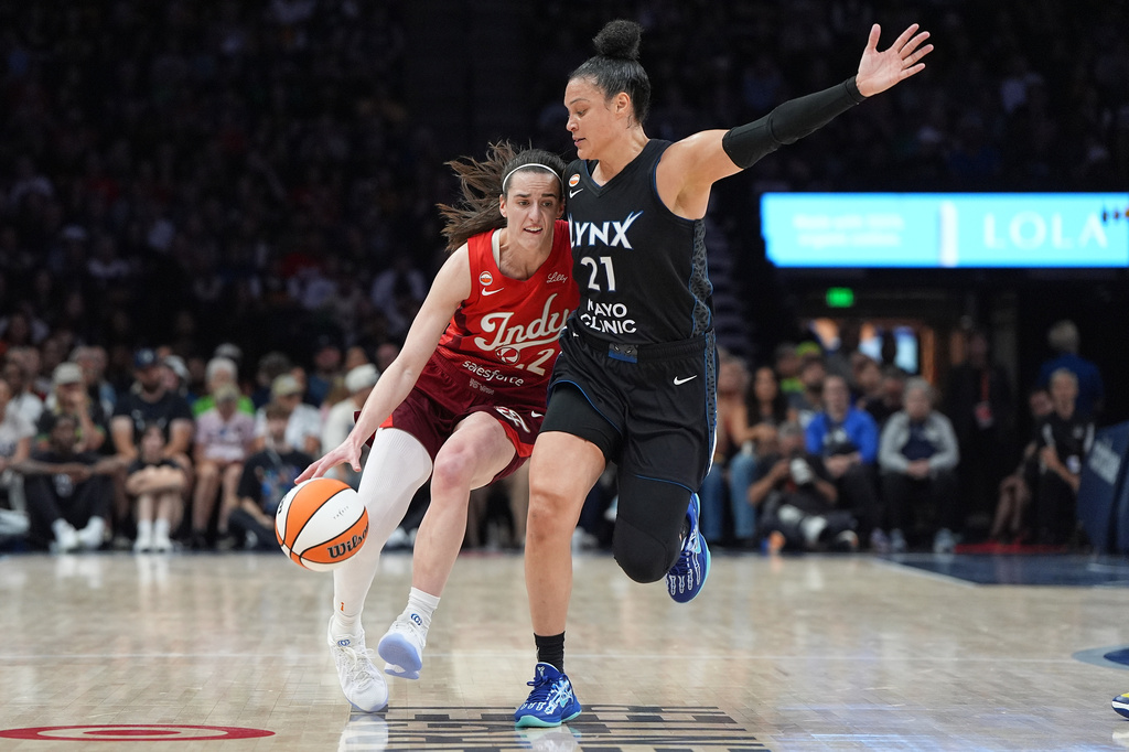 Indiana Fever guard Caitlin Clark, left, dribbles downcourt as Minnesota Lynx guard Kayla McBride (21) defends during the first half of a WNBA basketball game Sunday, Aug. 2, 2026, in Minneapolis. (AP Photo/Abbie Parr)