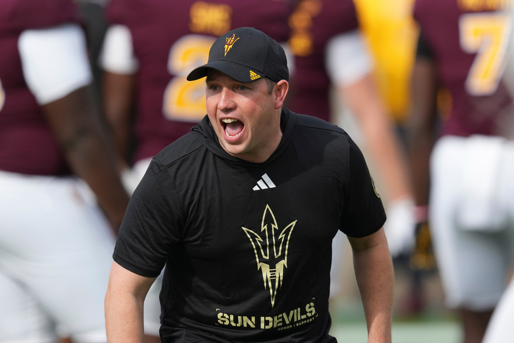 FILE - Arizona State head coach Kenny Dillingham encourages his players prior to an NCAA college football game against West Virginia Saturday, Nov. 15, 2025, in Tempe, Ariz. (AP Photo/Ross D. Franklin, File)