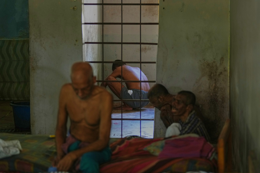 Residents spend the day inside their dormitory at a nursing home, where inmates of another nursing home that caught fire on Wednesday are being temporarily housed, in Anguruwatota, Sri Lanka, Friday, June 5, 2026. (AP Photo/Eranga Jayawardena)