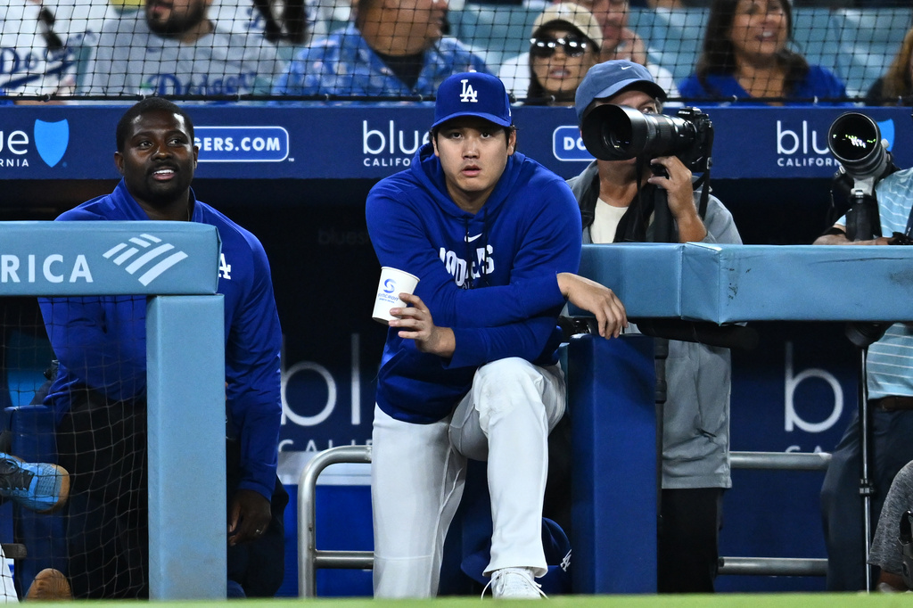 Los Angeles Dodgers' Shohei Ohtani, center, looks on during the eighth inning of a baseball game against the Washington Nationals, Friday, Sept. 4, 2026, in Los Angeles. (AP Photo/William Liang)