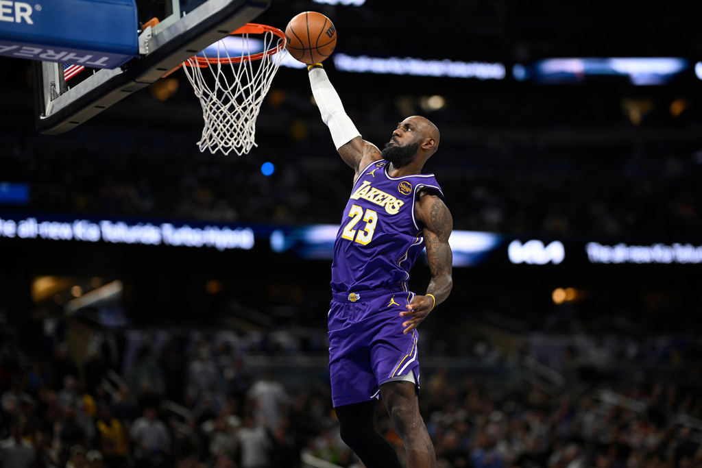 Los Angeles Lakers forward LeBron James (23) scores on a breakaway dunk during the first half of an NBA basketball game against the Orlando Magic, Saturday, March 21, 2026, in Orlando, Fla. (AP Photo/Phelan M. Ebenhack)
