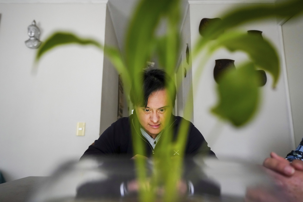 Actor Sebastián Solorza, who has Down syndrome and aims to run for president as an independent candidate, relaxes in his home in Santiago, Chile, Thursday, July 31, 2025. (AP Photo/Esteban Felix)
